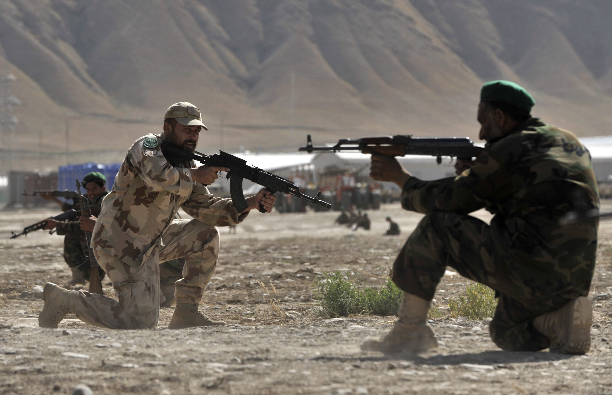 Hungarian military adviser Sfc. Imre Szekely, center, trains the members of the Afghan National Army in the Camp Kelagay (210km/130miles north of Kabul), Baghlan province of Afghanistan, Saturday, June 4, 2003. In Kelagay, members of the Ohio National Guard and the Hungarian Army work together training the Afghan National Army. (AP Photo/Bela Szandelszky)